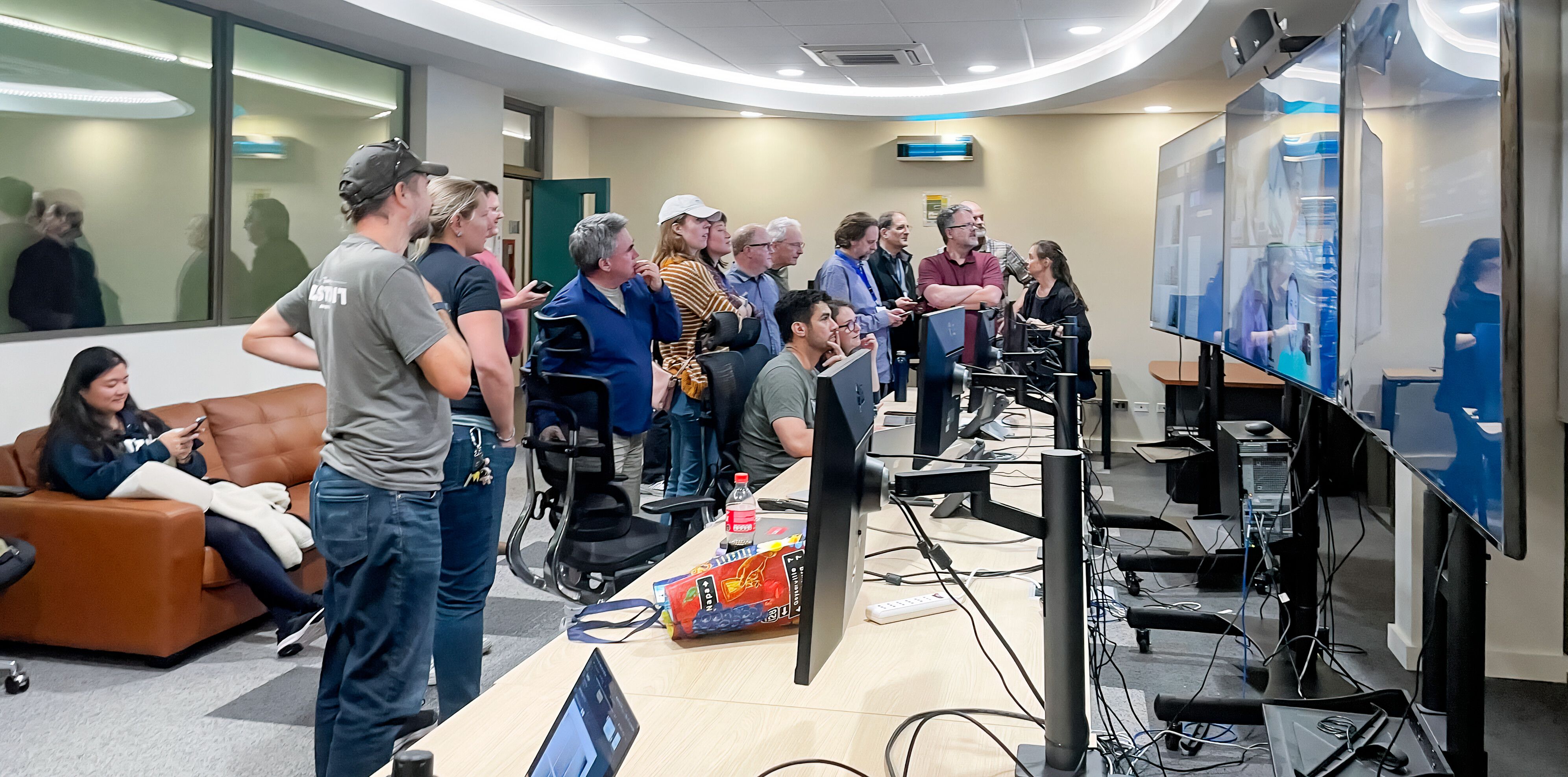 Operations control room with operators reviewing live system data.